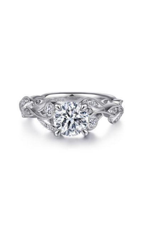 A white gold sidestone floral engagement ring with center round cut diamond