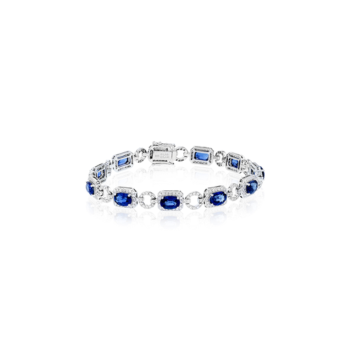 A white gold bracelet featuring alternating blue gemstones and diamonds.