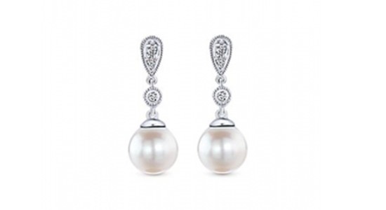 a pair of pearl drop earrings with diamond accents