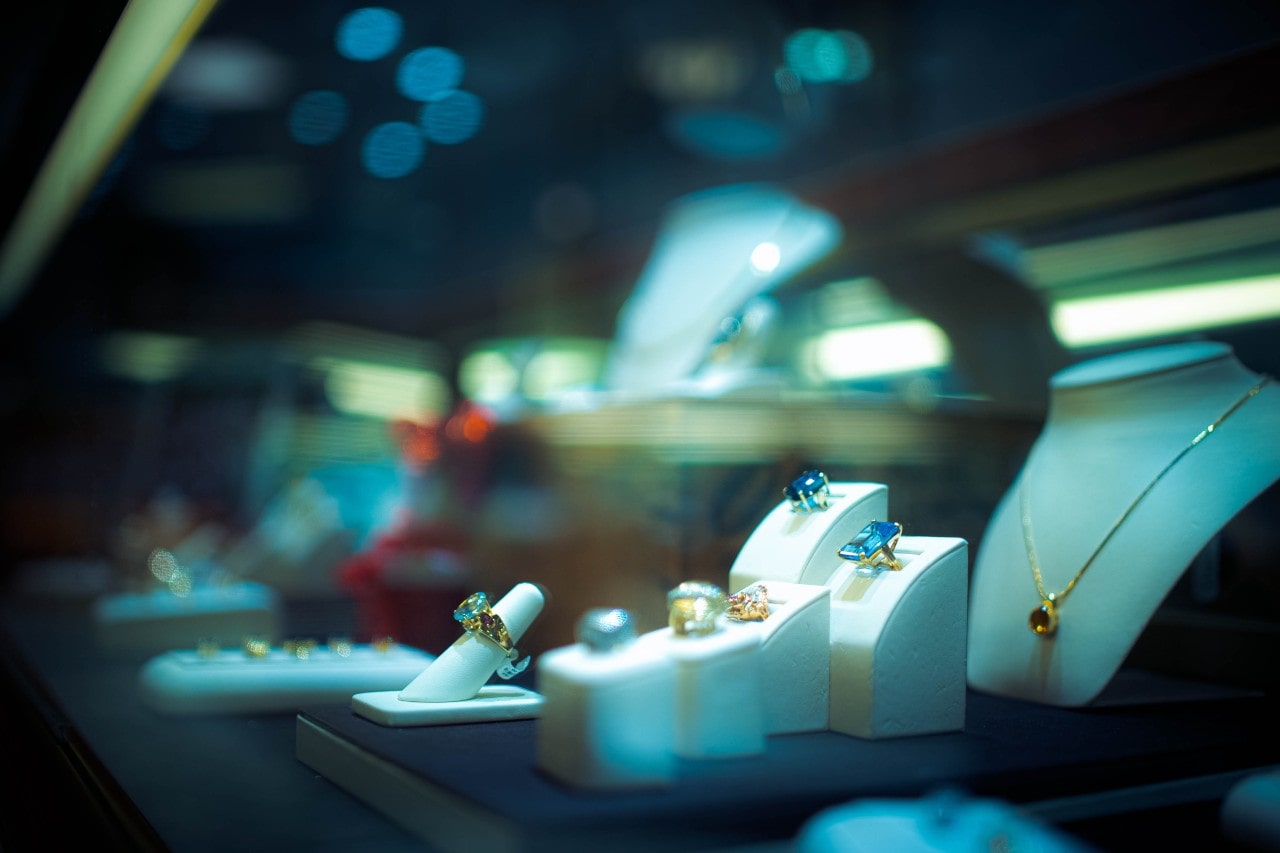a jewelry display case with necklaces and rings at a jewelry store